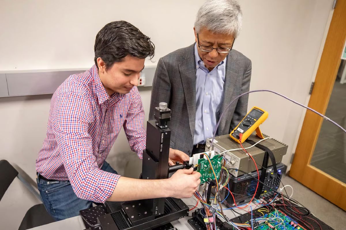 Electrical engineering student Walter Sosa Portillo (left) and Dr. Kenneth O (right) work on the microchip imager for handheld mobile devices